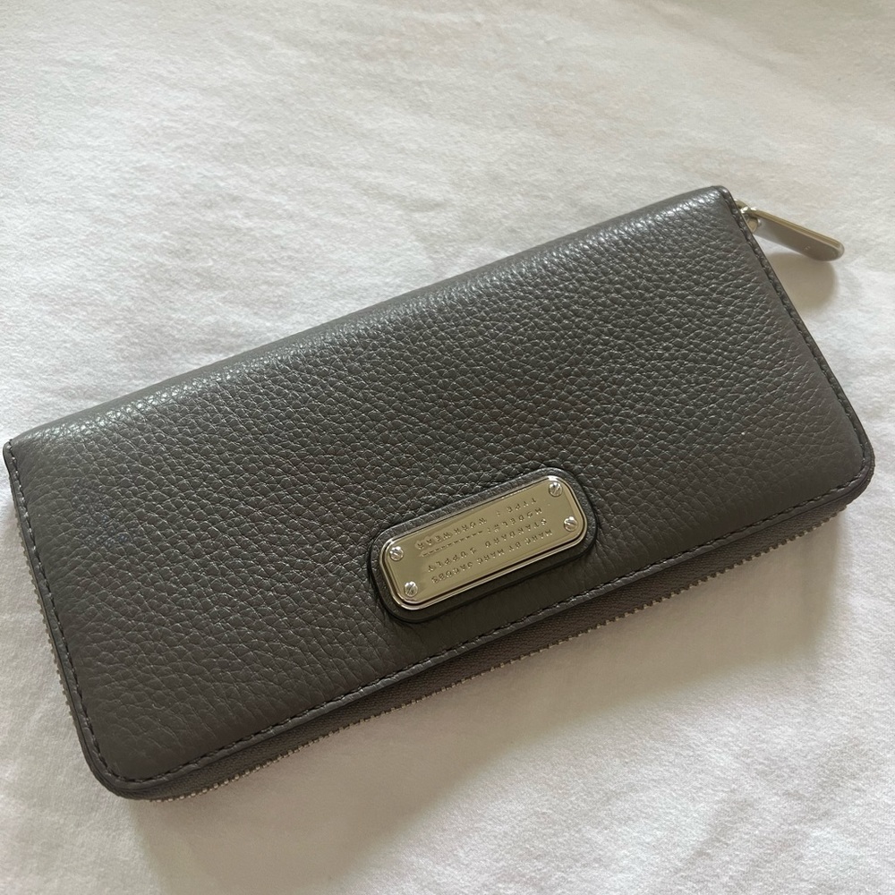 Continental wallet has 2 bill sleeves, 8 card slots, and an interior zip pouch.